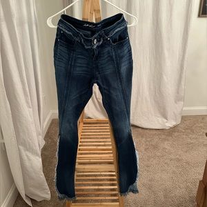 Flare jeans. Slit on leg with cute design.